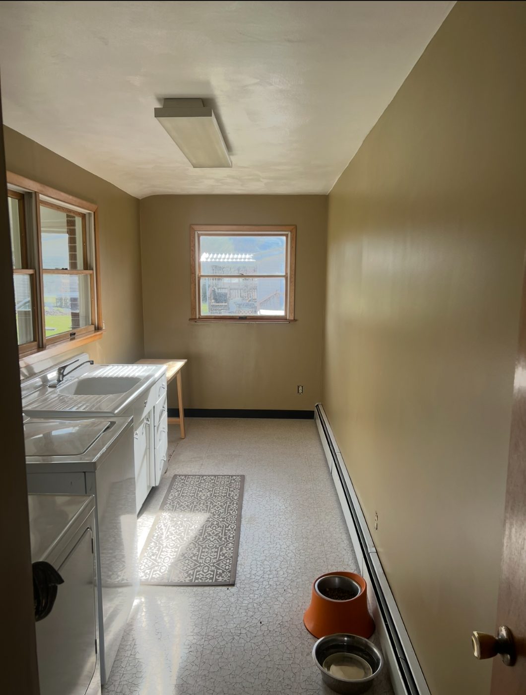 After: laundry room repainted in warm tan with white trim in State College, PA