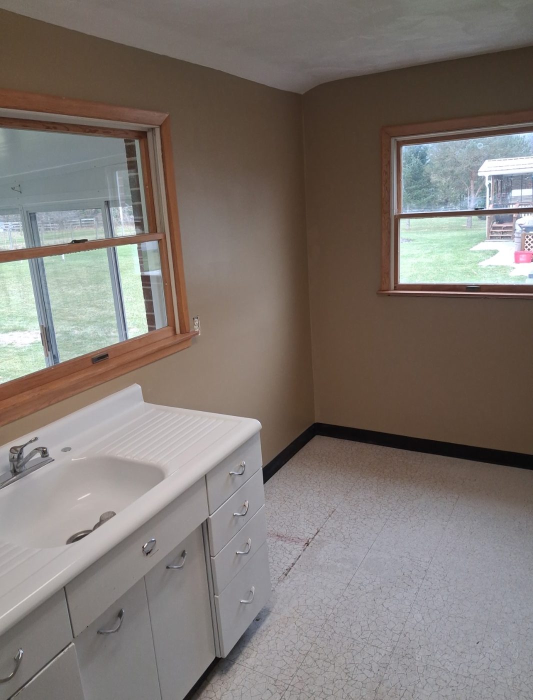 Utility room with smooth tan walls and white window trim