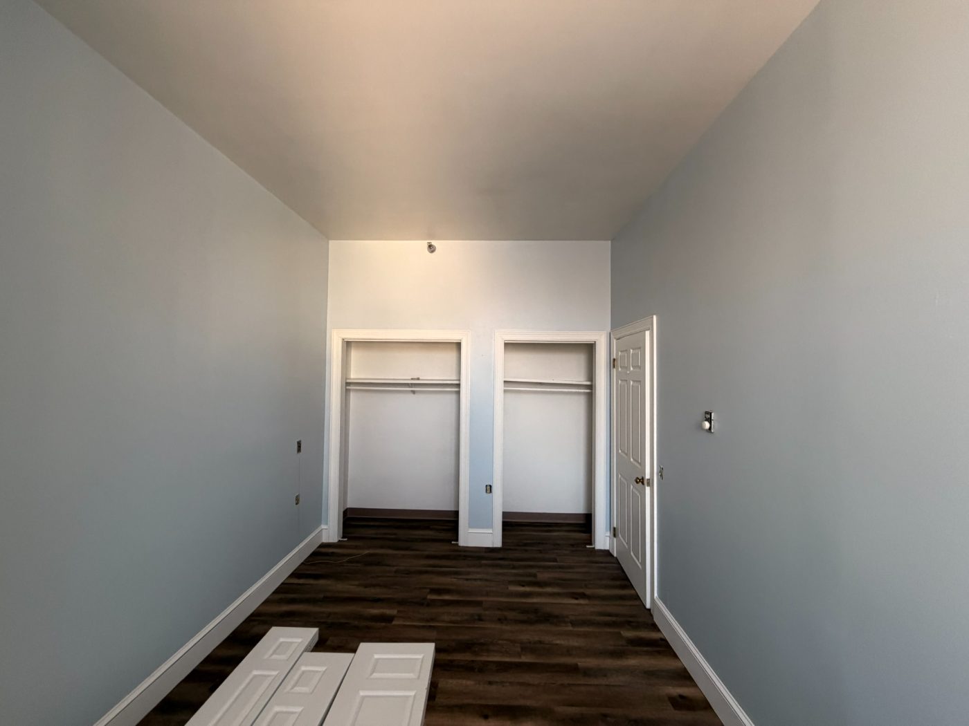 Freshly painted hallway with built-in closet and crisp white doors